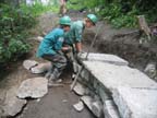 Sliding a rock into place.