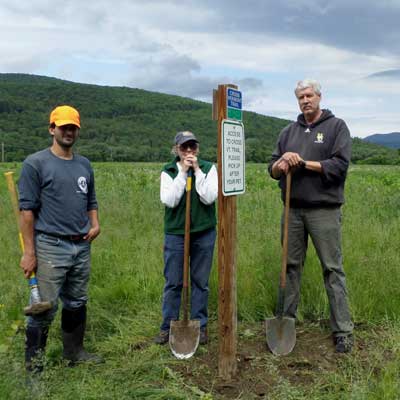 volunteers install sign