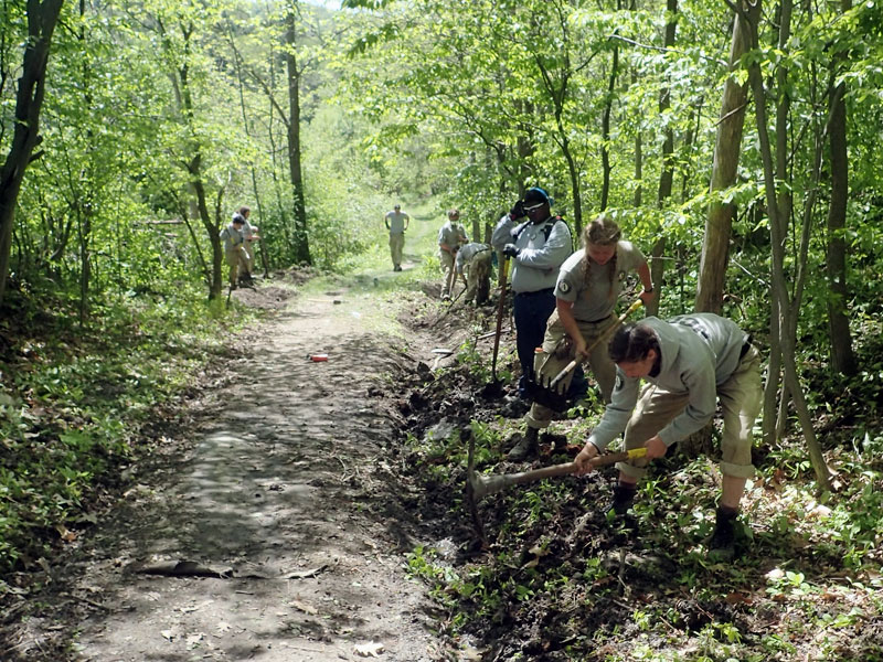 Americorps crew digs a drainage