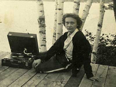 woman on dock with record player