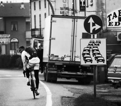 man bikes on busy street