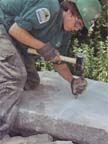 chiseling a line to split a granite slab