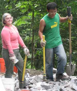 volunteers sledge stone for fill