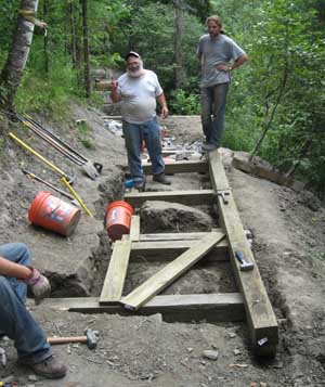 volunteers building approach to bridge