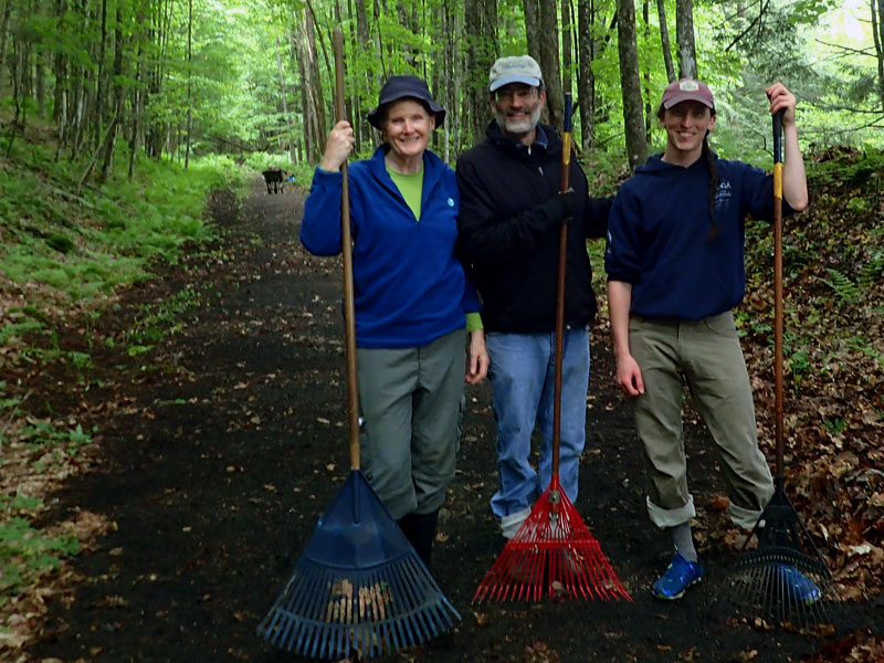 trail volunteers with rakes