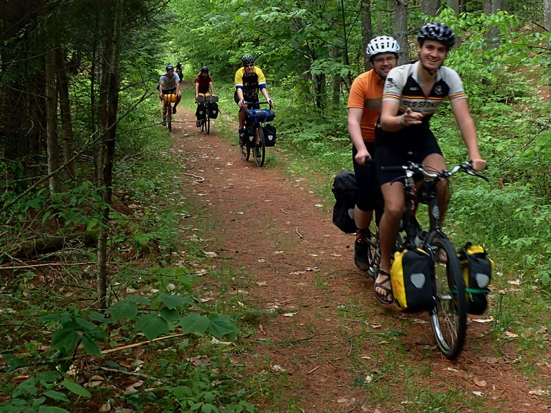 bike riders with panniers and thumbs up